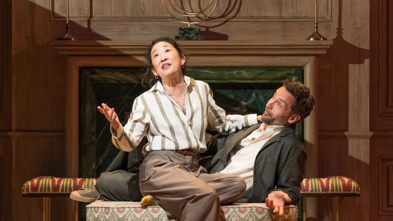 Sandra Oh sitting with a man